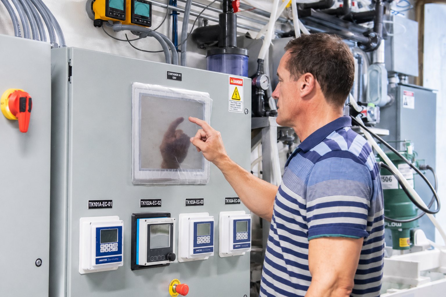Rick Stover operating the control panel of a membrane treatment system