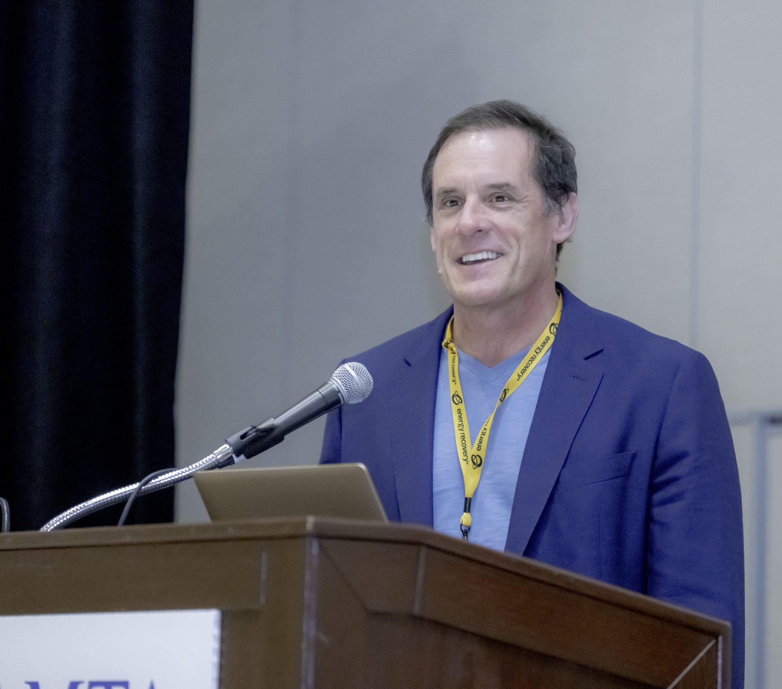 Rick Stover speaking at a conference podium